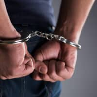 ManWithHisHandsHandcuffedInCriminalConcept