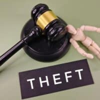 TheftWordOnBlackCardWithJudgeGavelAndWooden