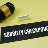 SobrietyCheckpointConceptWithJudgeGavelLawEnforcementTrafficControl