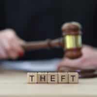 TextTheftAndFemaleJudgeKnockingGavelAtCourtyardArbiter