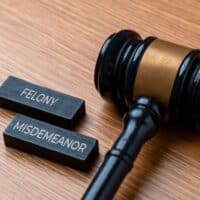 AJudgesGavelNextToWoodenBlocksLabeledFelonyAnd